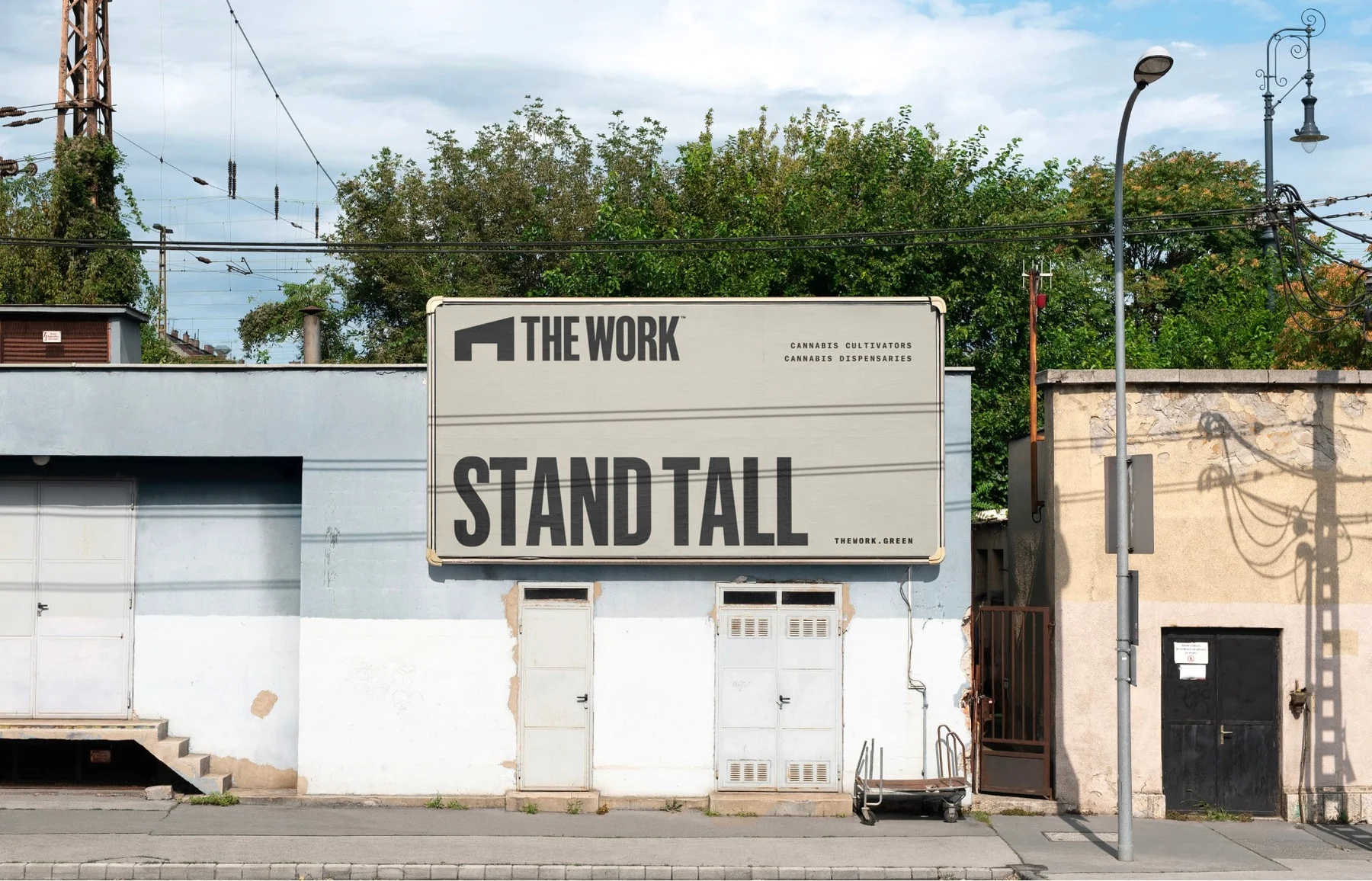 The Work roadside billboard reading Stand Tall.