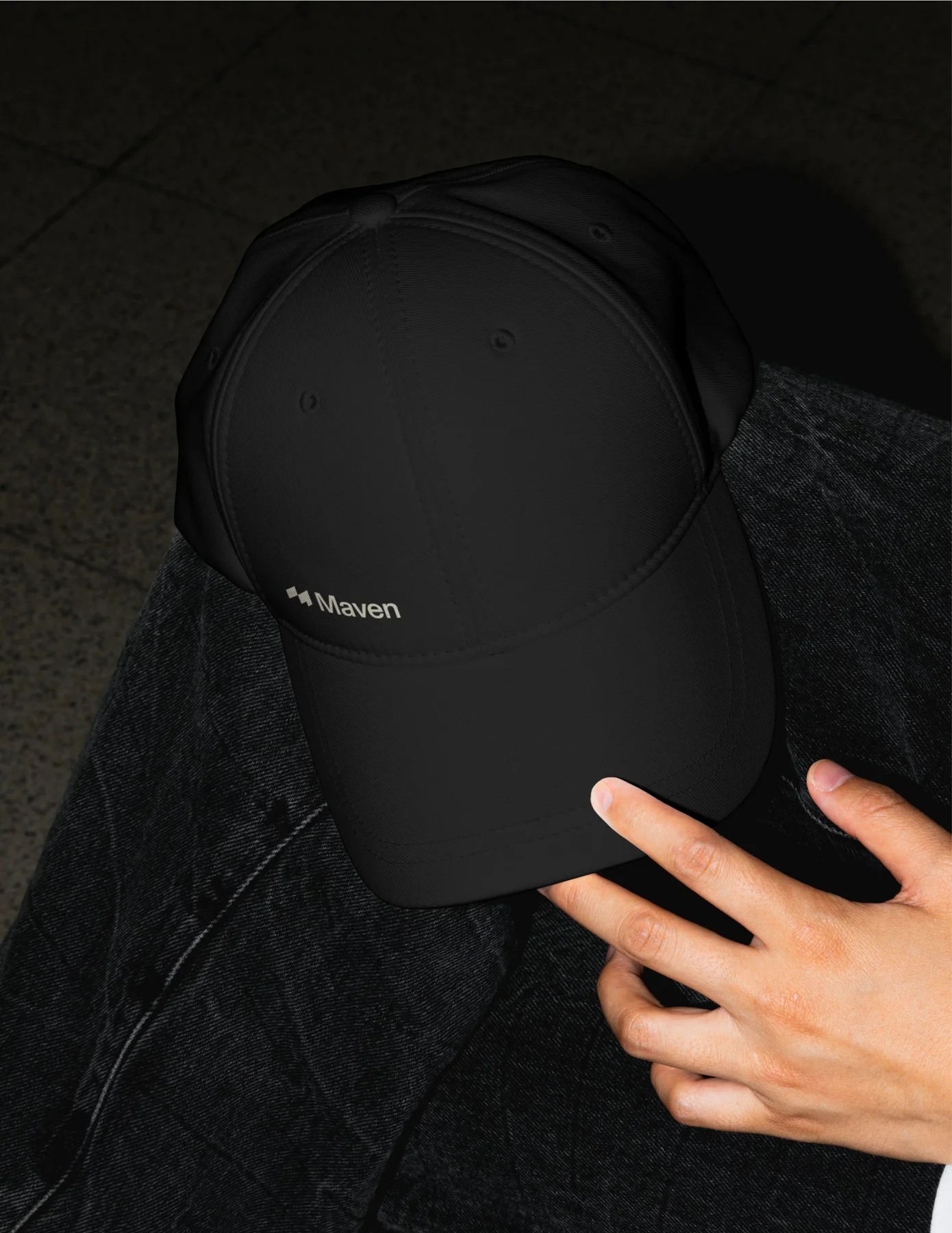 Person wearing a black Maven cap.