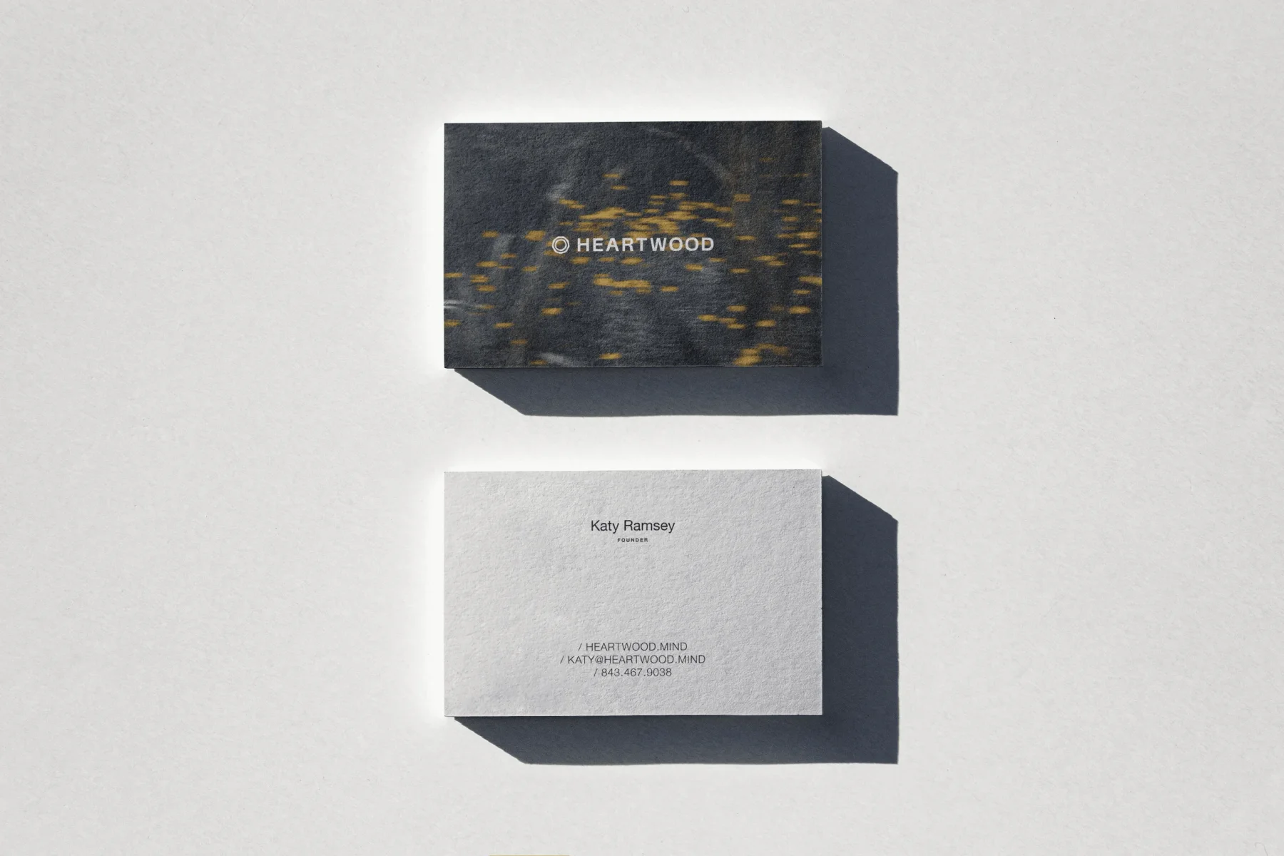 Heartwood business cards combining forest photography and restrained typography.