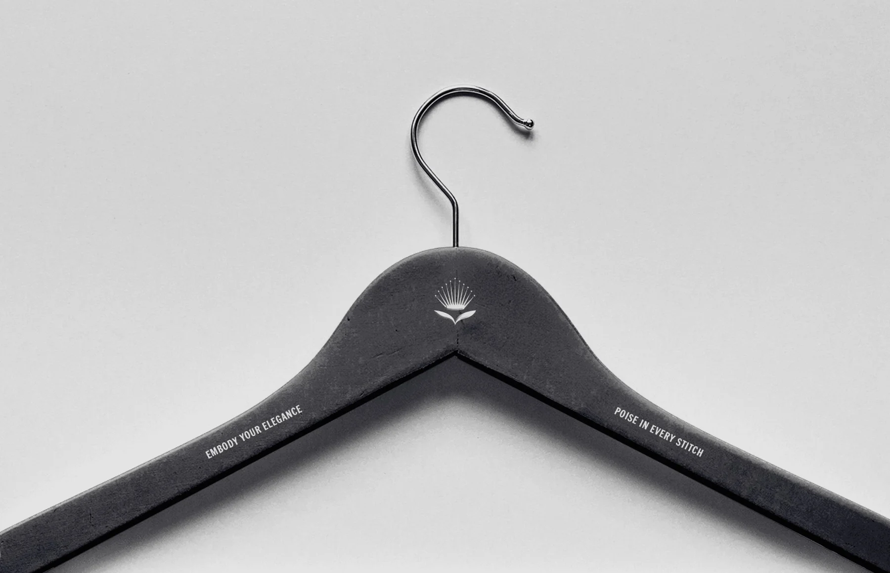Black clothes hanger with a small Donna Beth emblem.