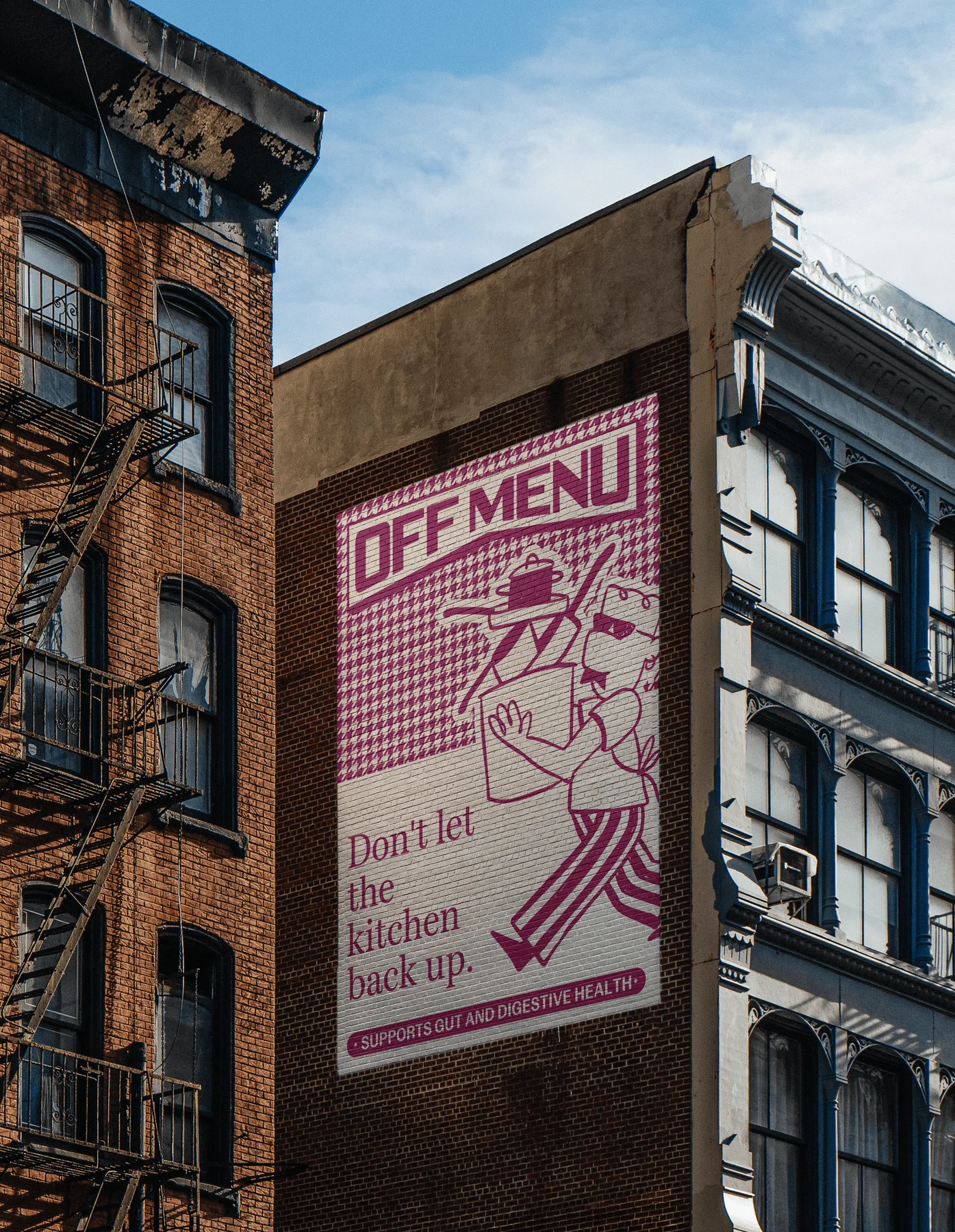 Tall pink Off Menu poster on a brick building.