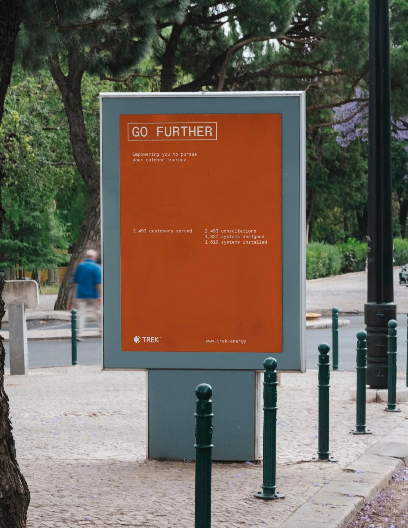 Orange Trek street poster headed Go Further.