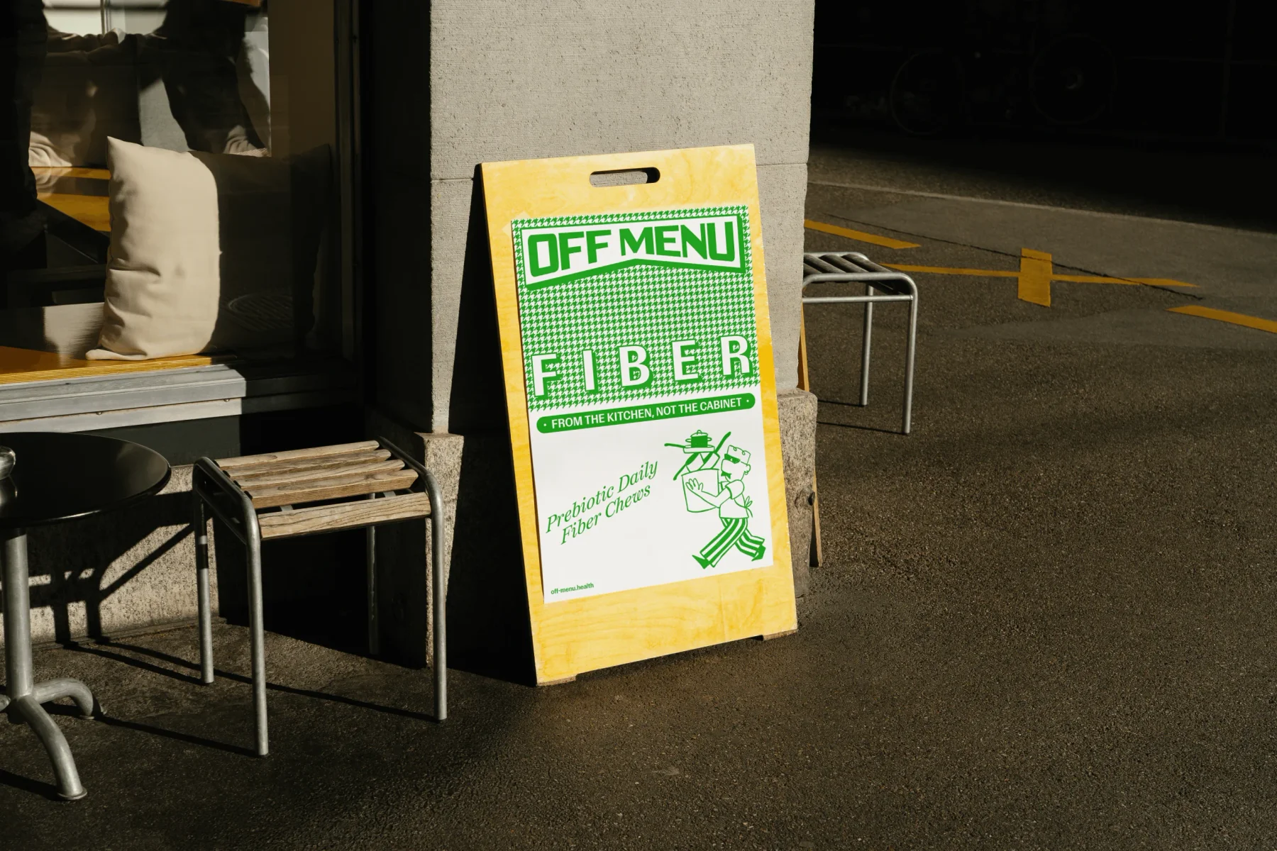 Green Off Menu fiber poster on a wooden sidewalk sign.