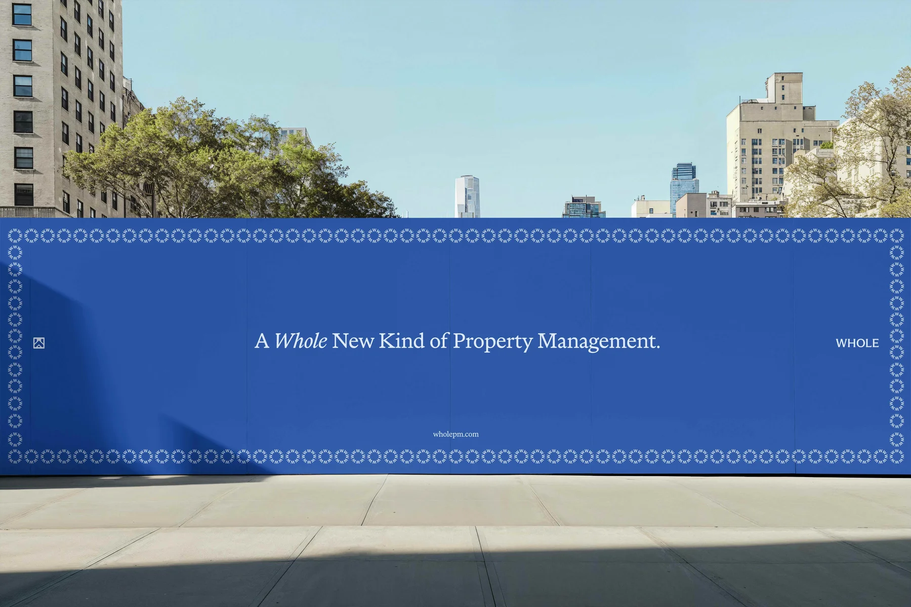 Blue Whole construction banner reading A Whole New Kind of Property Management.