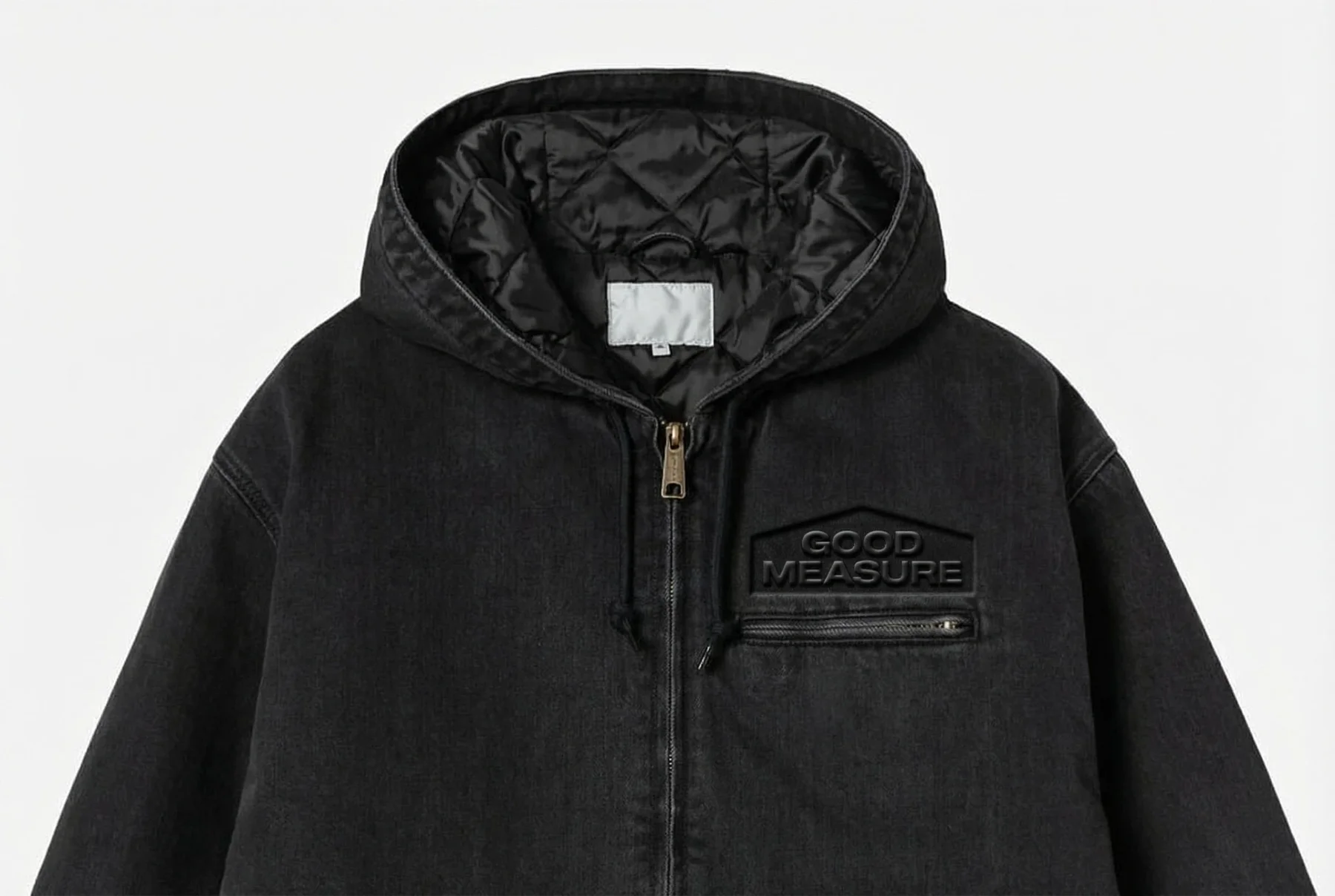 Black zip-up jacket with a tonal Good Measure patch.