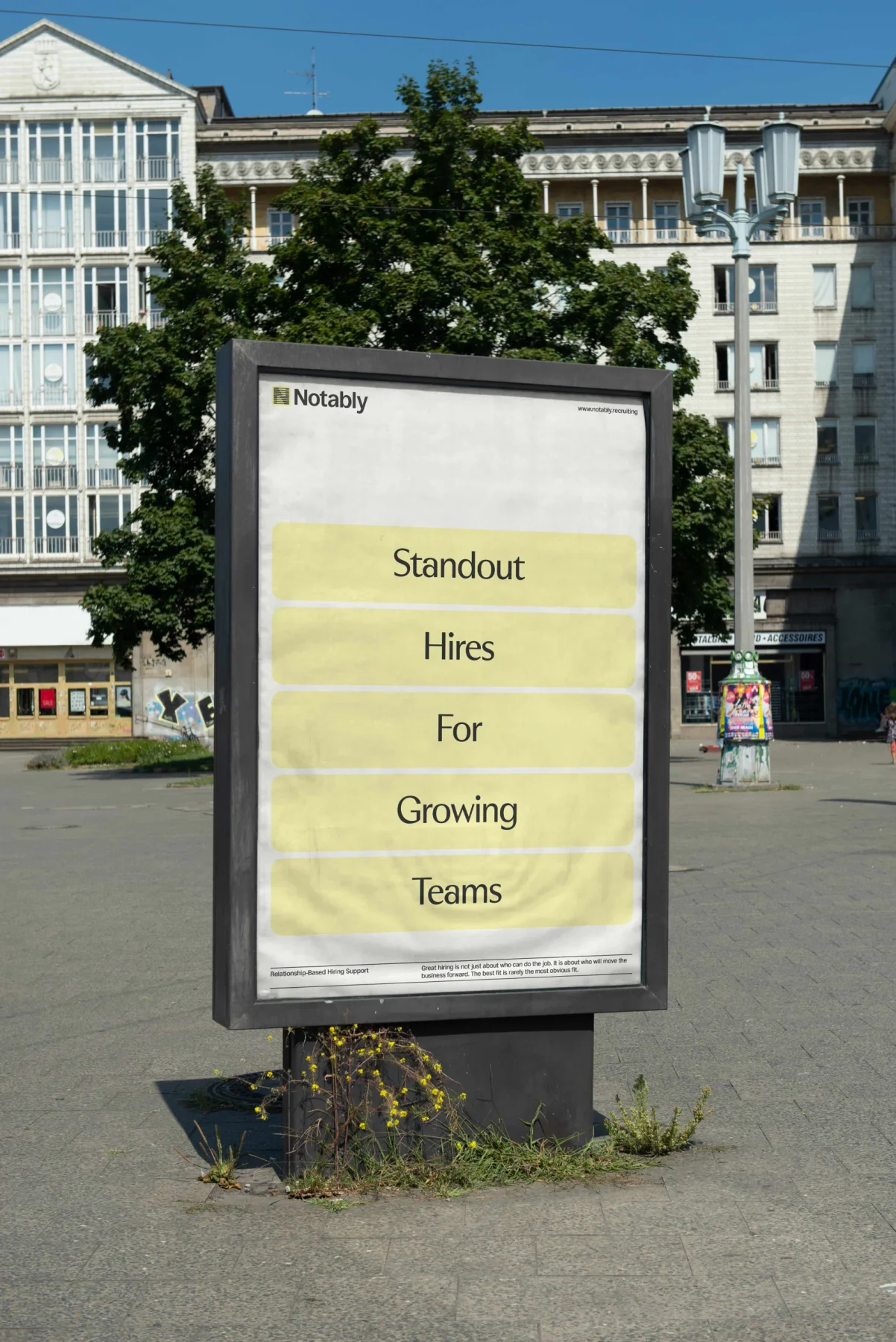 Notably bus-shelter poster with pale yellow blocks and centered typography.