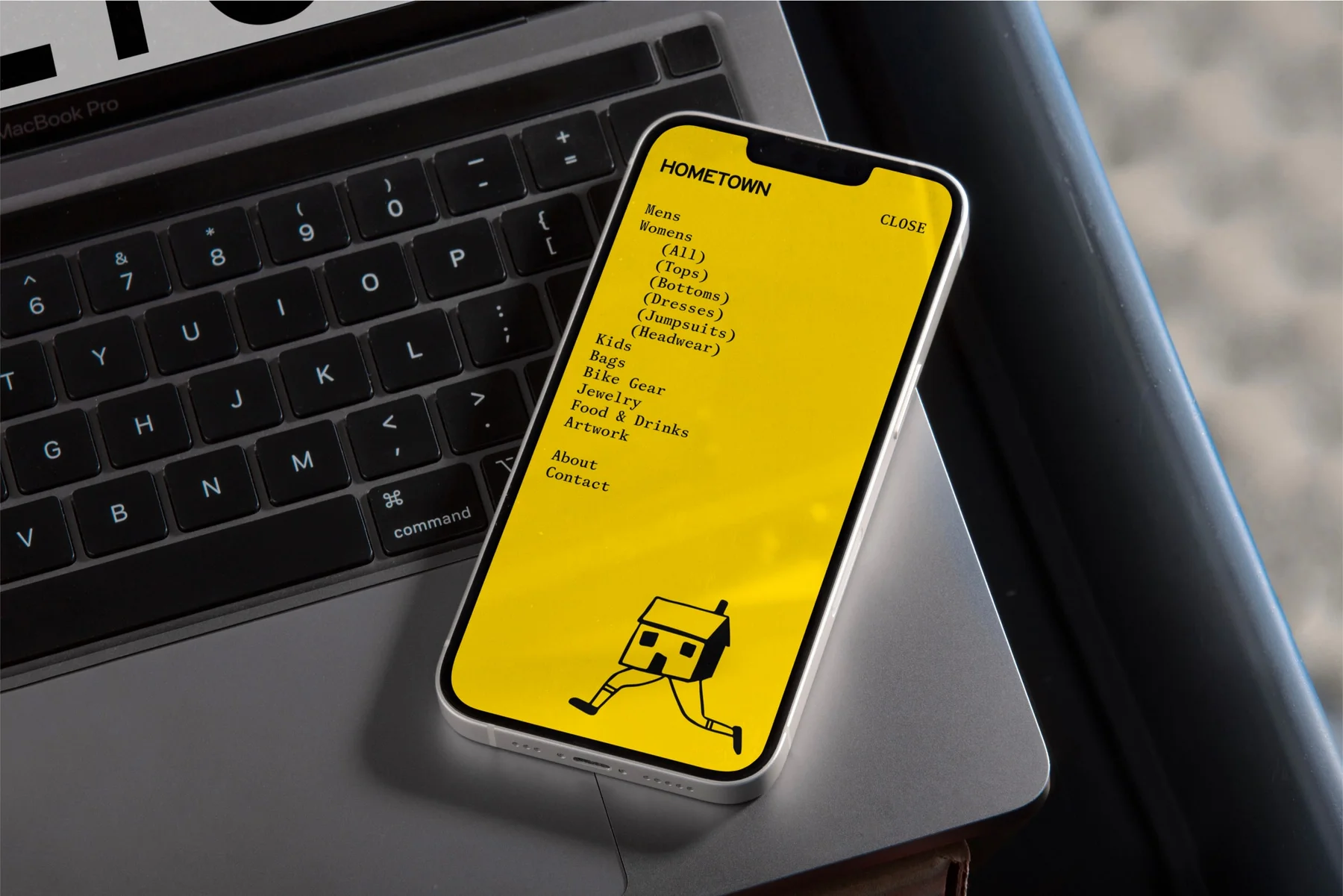 Yellow Hometown mobile page with a small illustrated character.