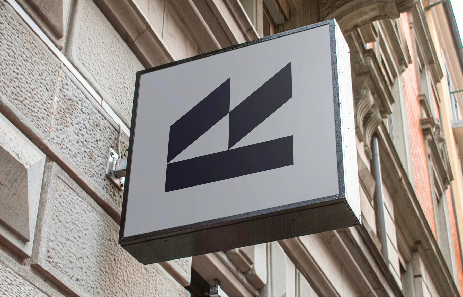 Square projecting sign with the Belzer Law geometric symbol.