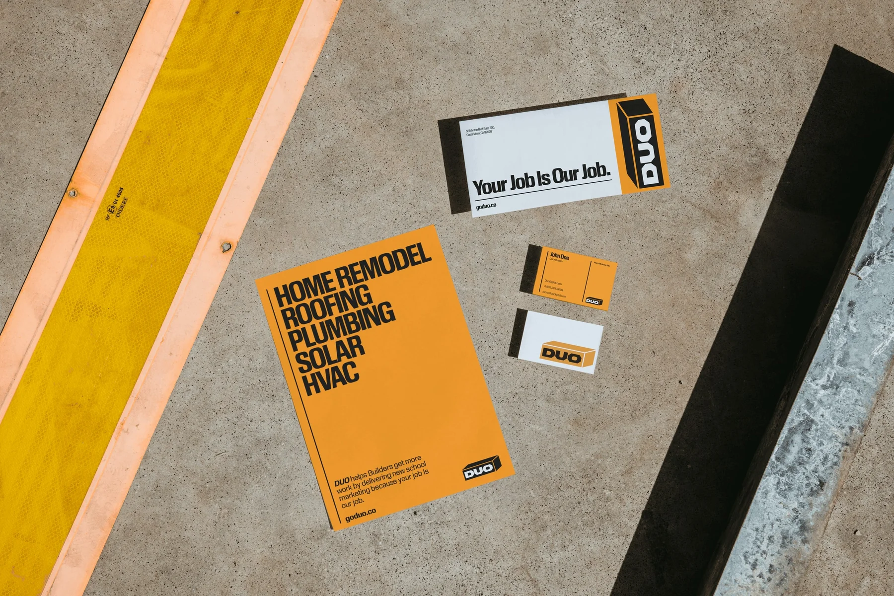 Orange and white Duo printed materials beside construction timber.