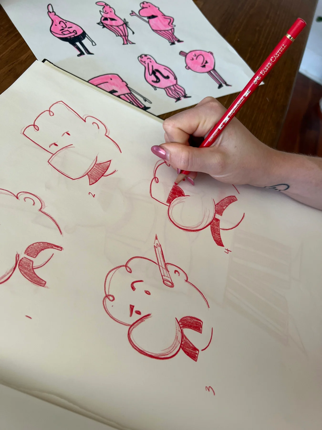 Hand drawing Off Menu chef characters in red pencil.
