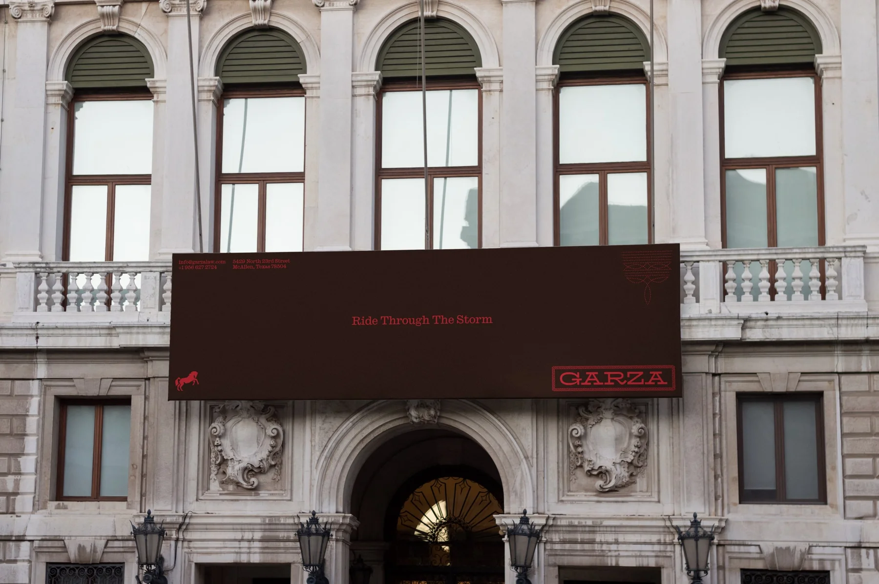 Wide Garza banner on an ornate building facade.