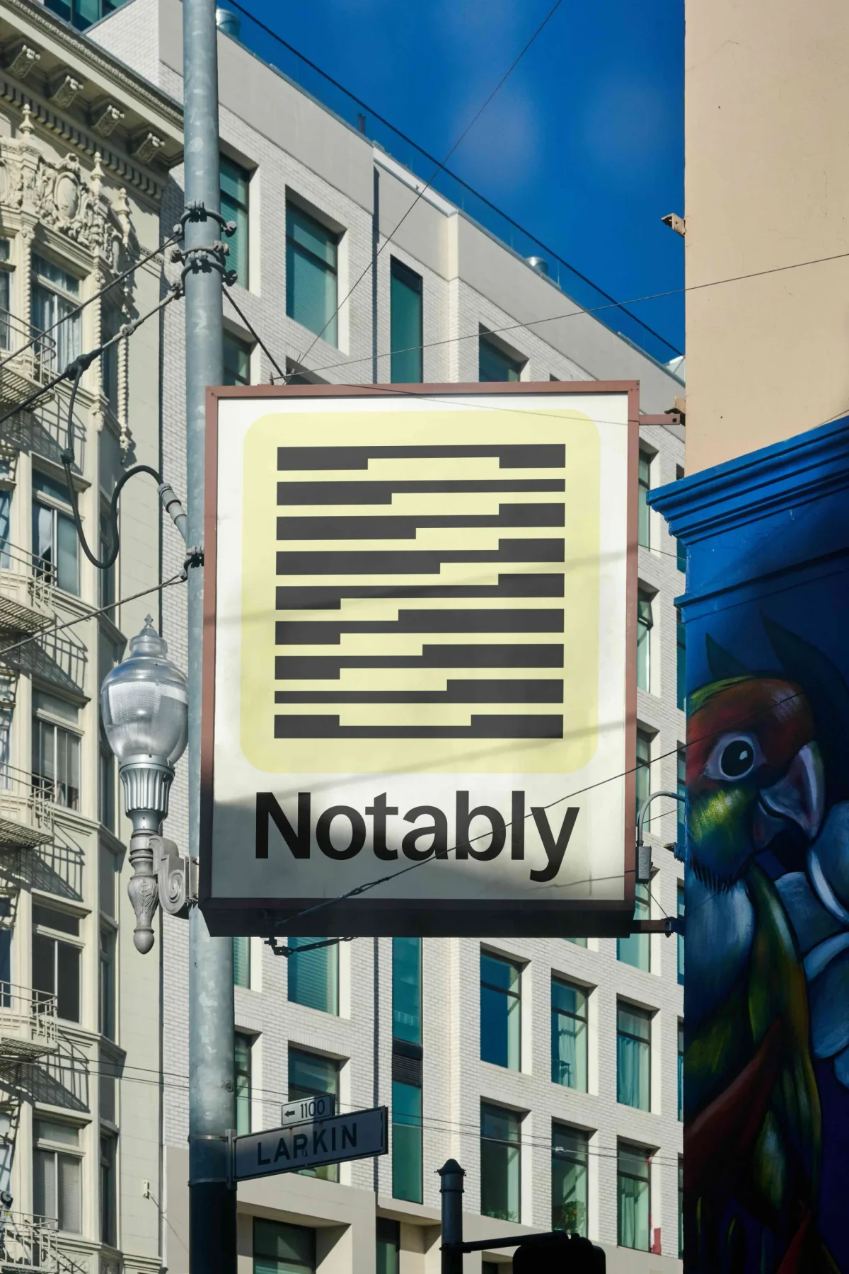 Notably projecting sign with a striped yellow emblem.