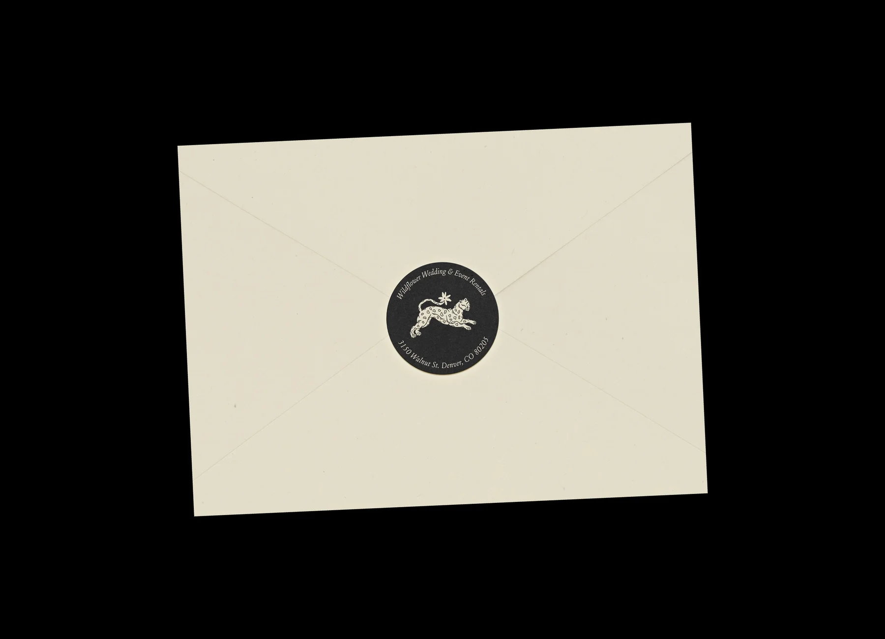 Cream Wildflower envelope sealed with a round black emblem.