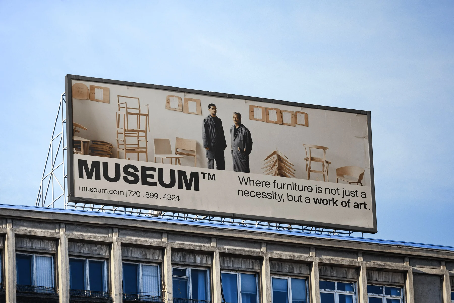 Museum billboard with furniture photography and bold typography.