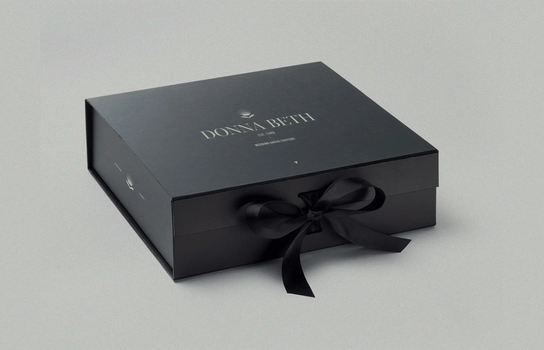 Black Donna Beth presentation box tied with a ribbon.