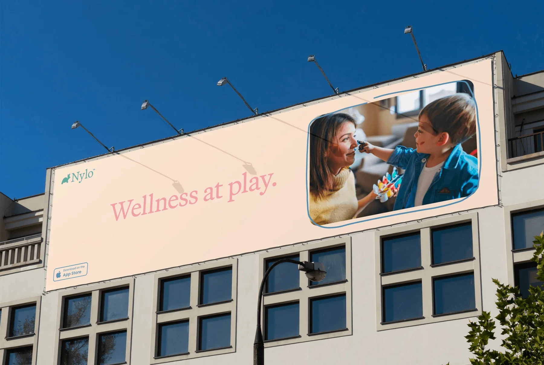 Nylo rooftop billboard reading Wellness at play beside a family photograph.