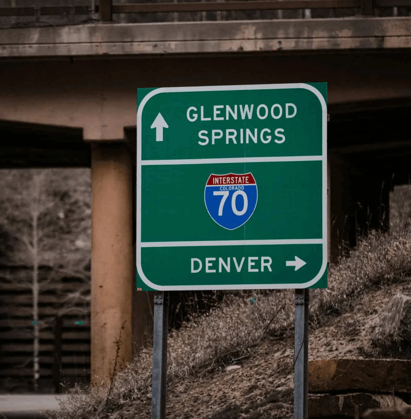 Road sign pointing toward Glenwood Springs and Denver.