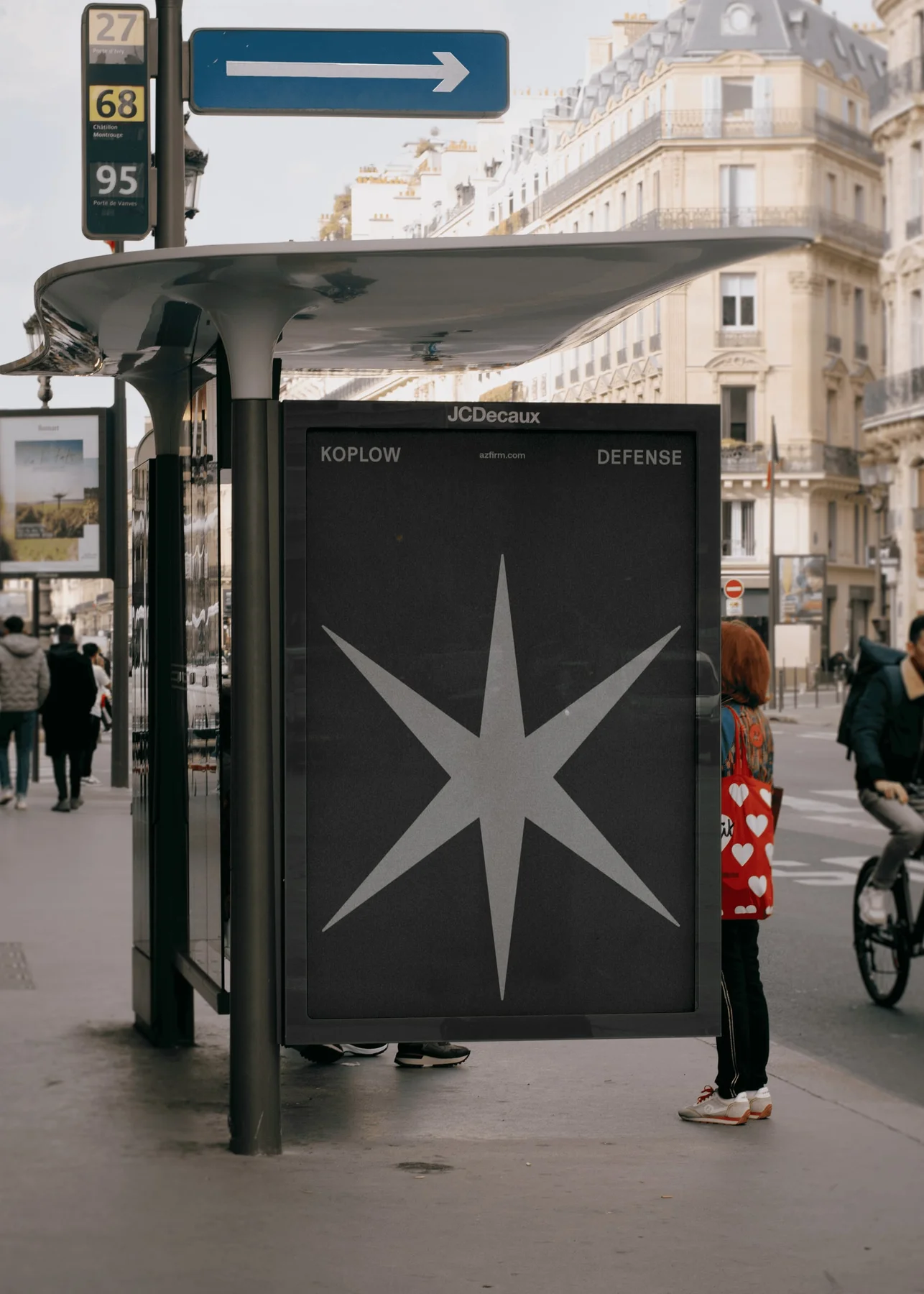 Black Koplow Defense bus-shelter poster with a large star.