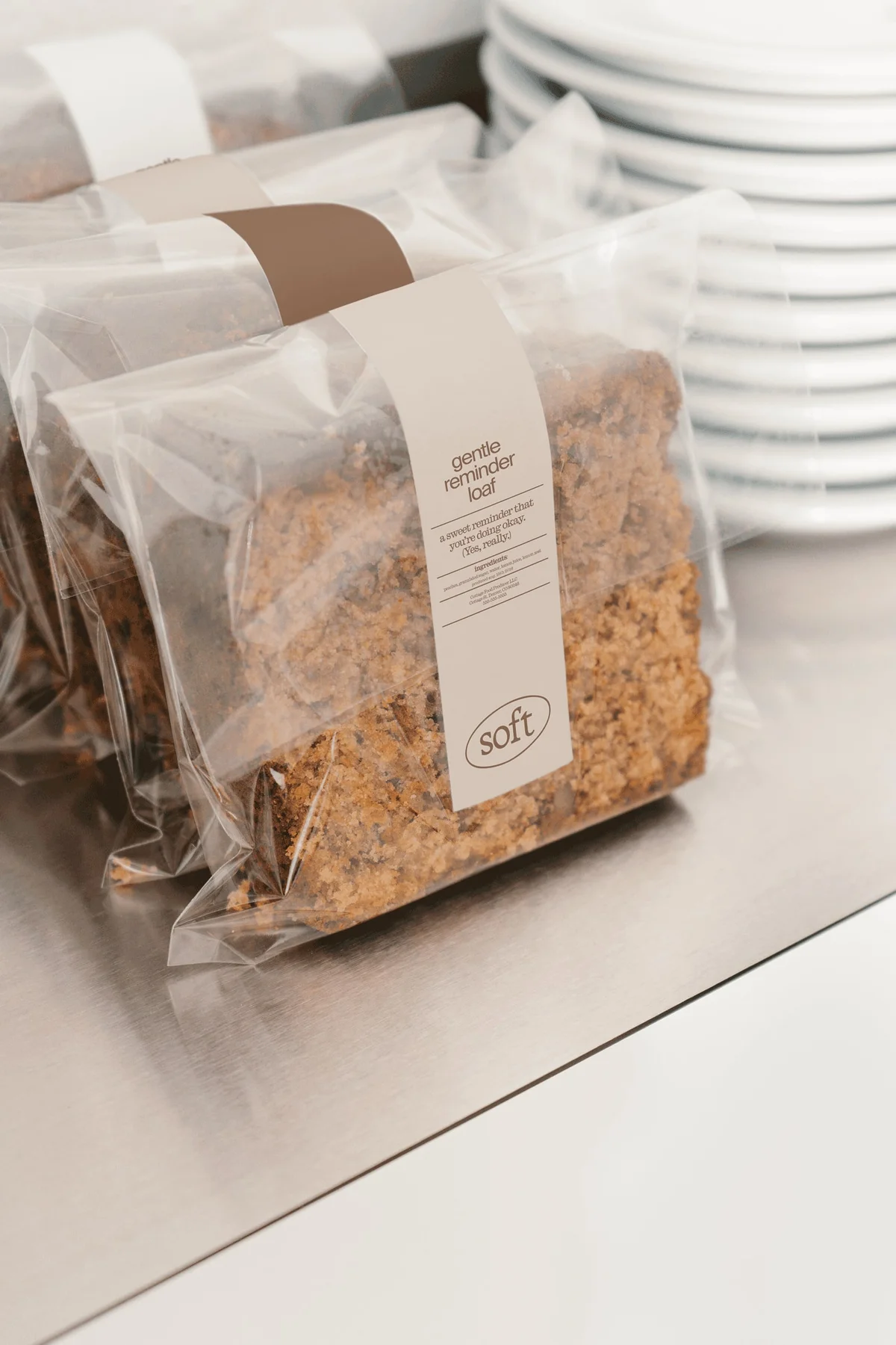 Soft bakery goods in transparent bags with narrow cream labels.