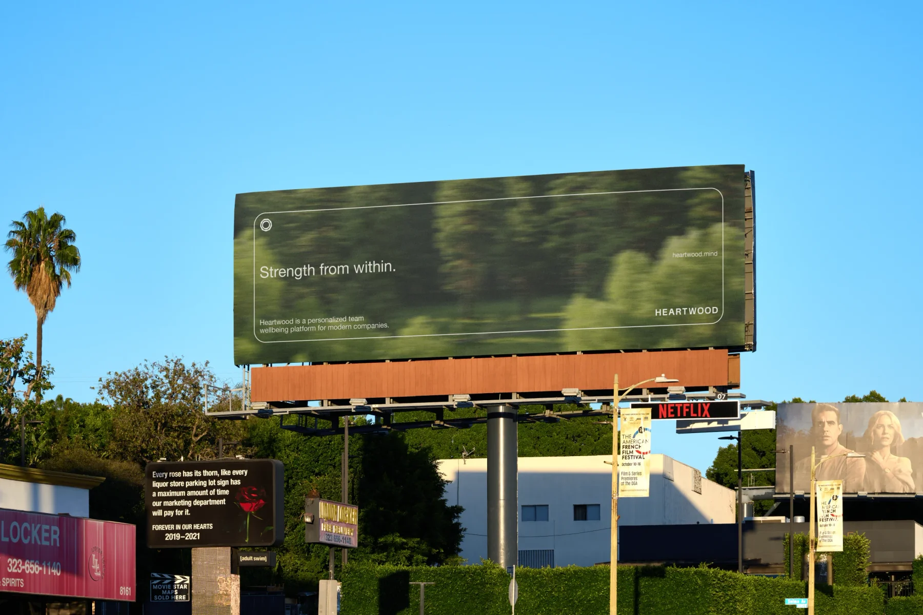 Heartwood billboard with blurred forest photography.