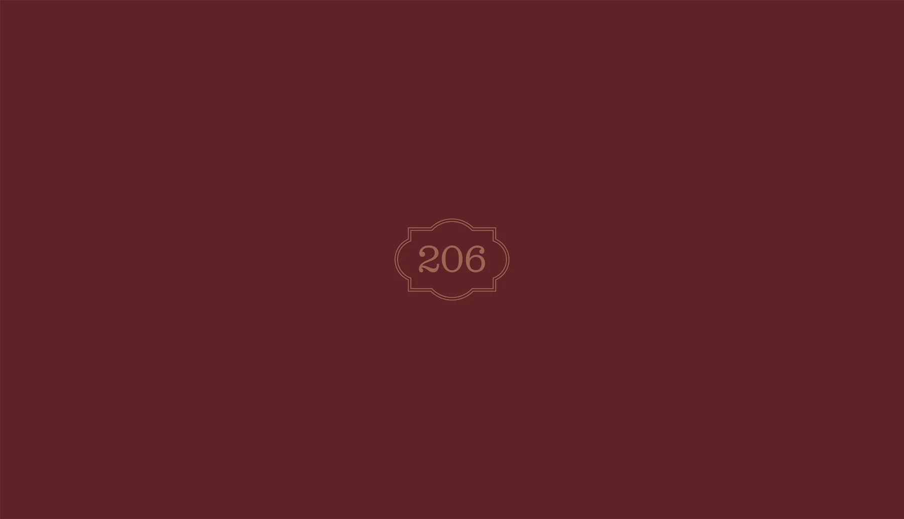 Scalloped 206 emblem in muted gold on a burgundy background.