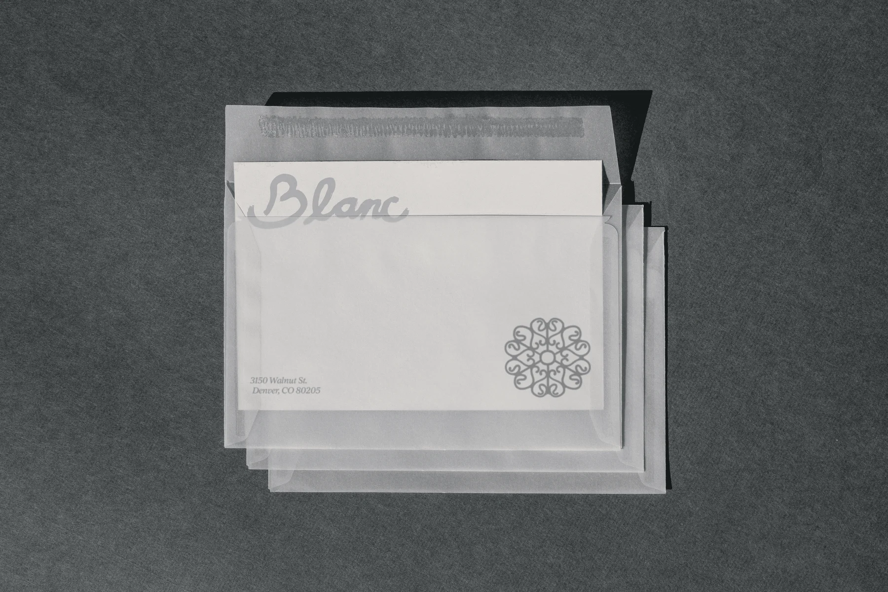 Layered translucent Blanc stationery with a circular ornament.