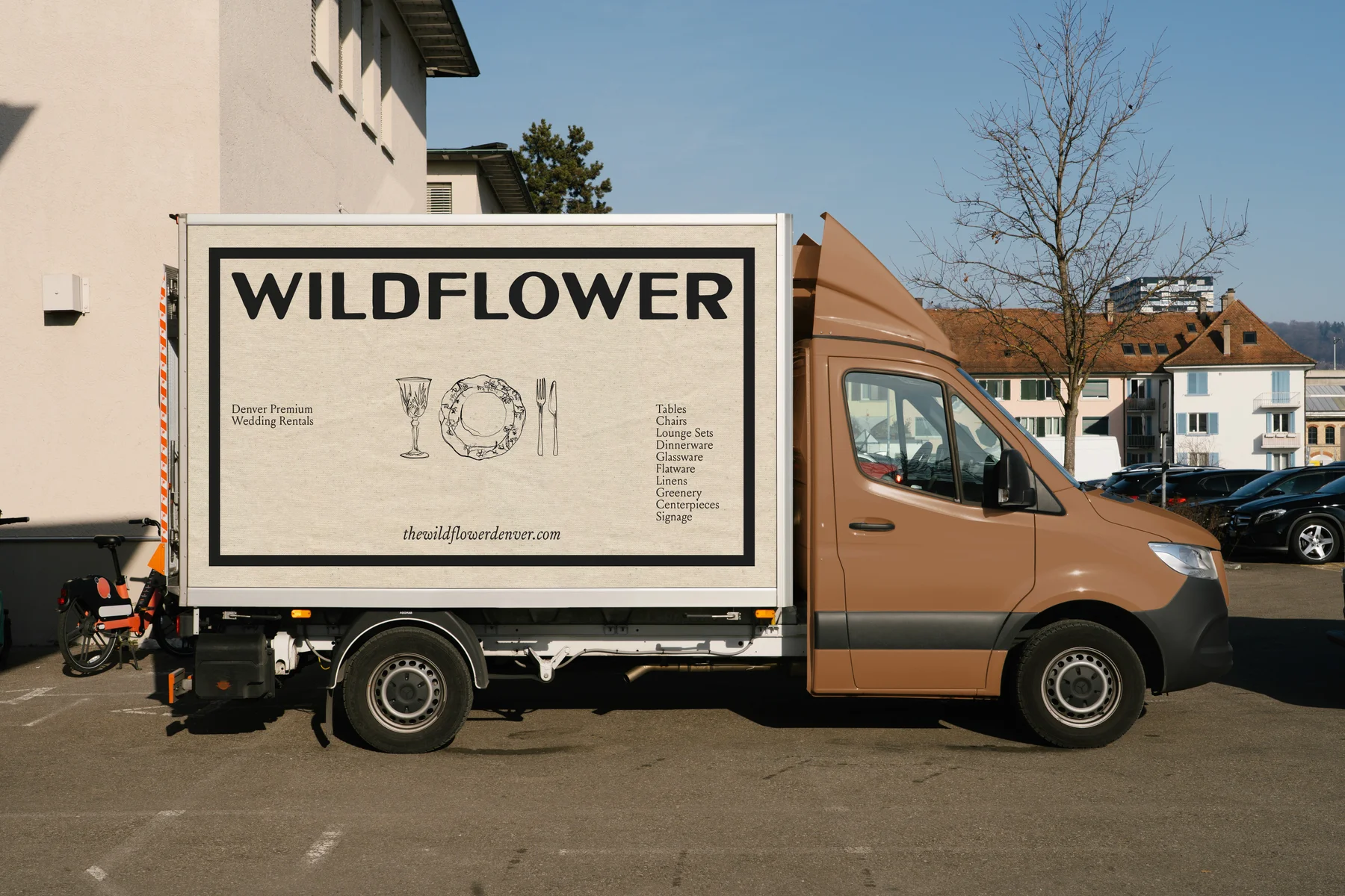 Brown Wildflower delivery truck with cream illustrated side panel.