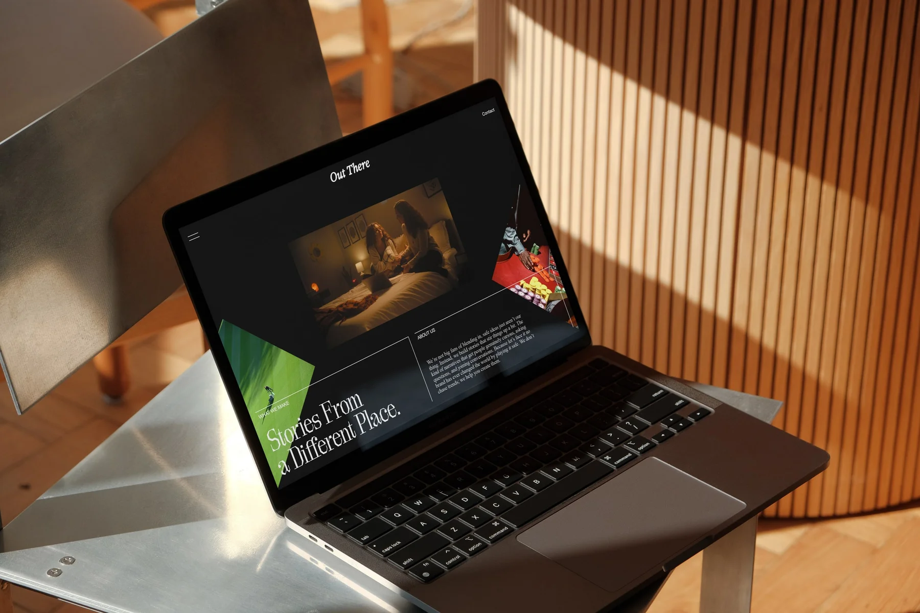 Out There website displayed on a laptop in sunlight.