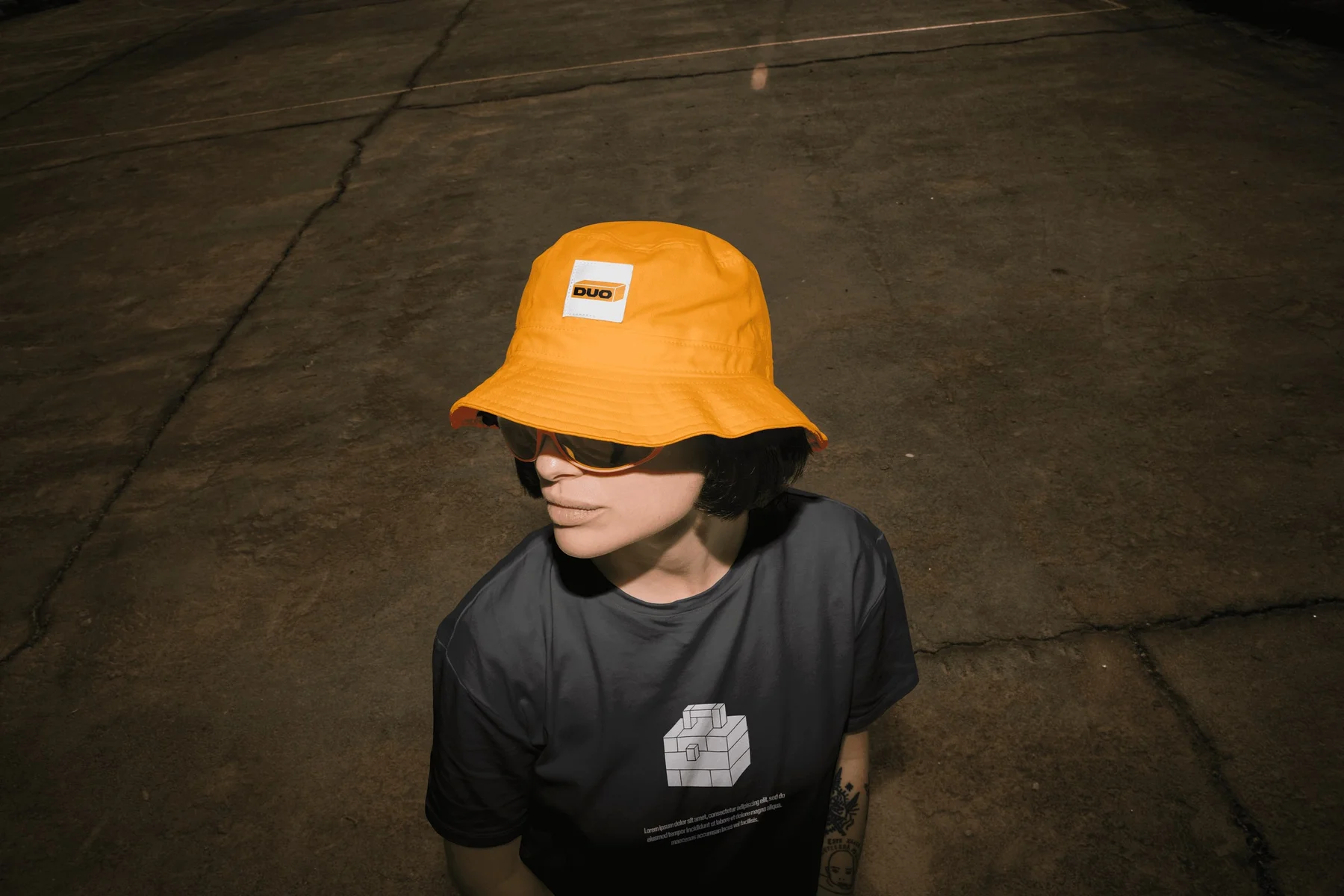 Person wearing an orange Duo bucket hat and black graphic T-shirt.