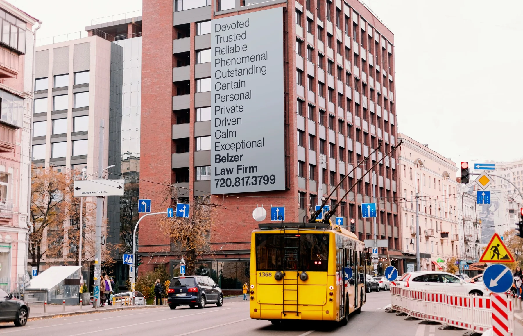 Tall Belzer Law typography banner on a city building.