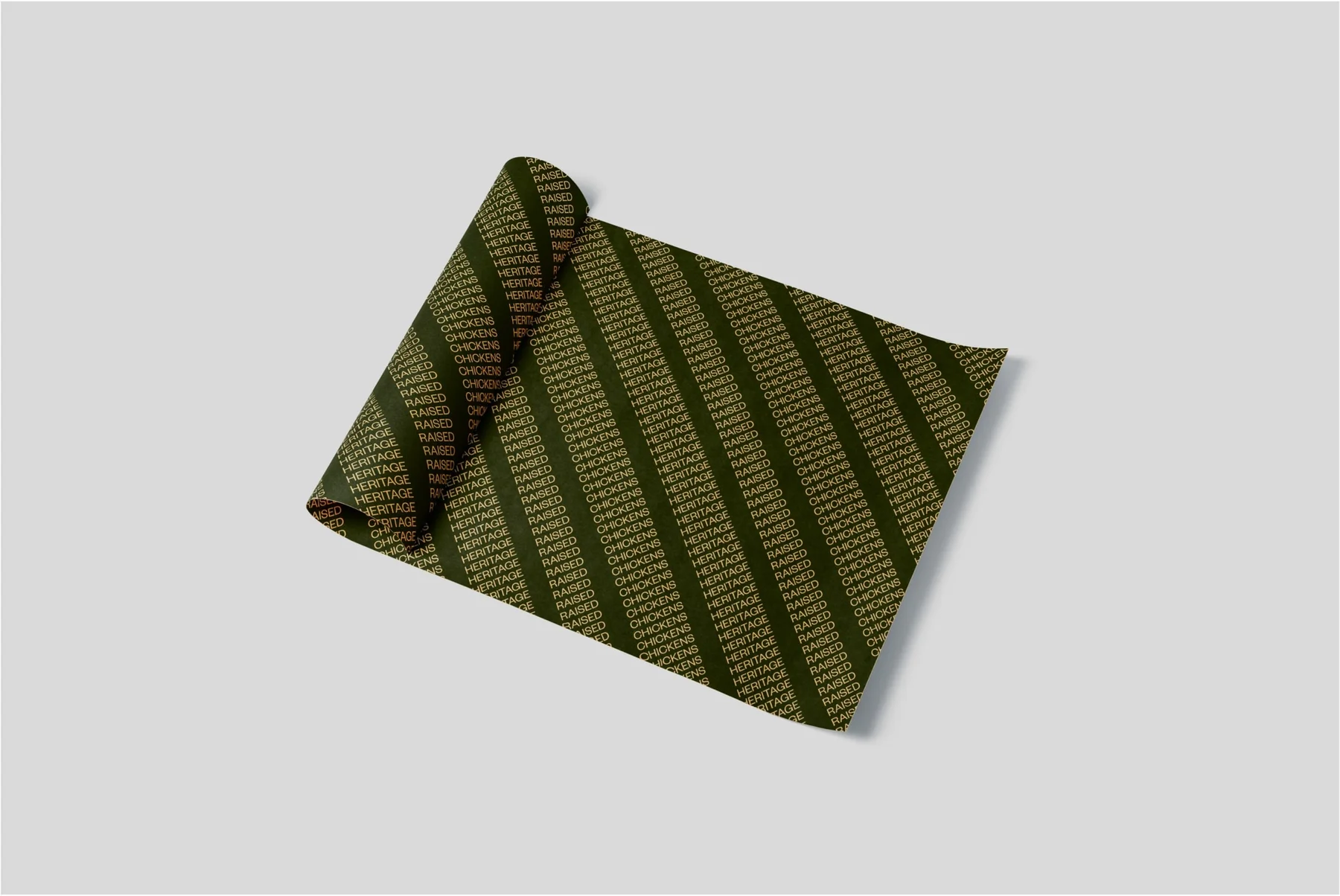Roll of dark green and gold patterned wrapping paper.