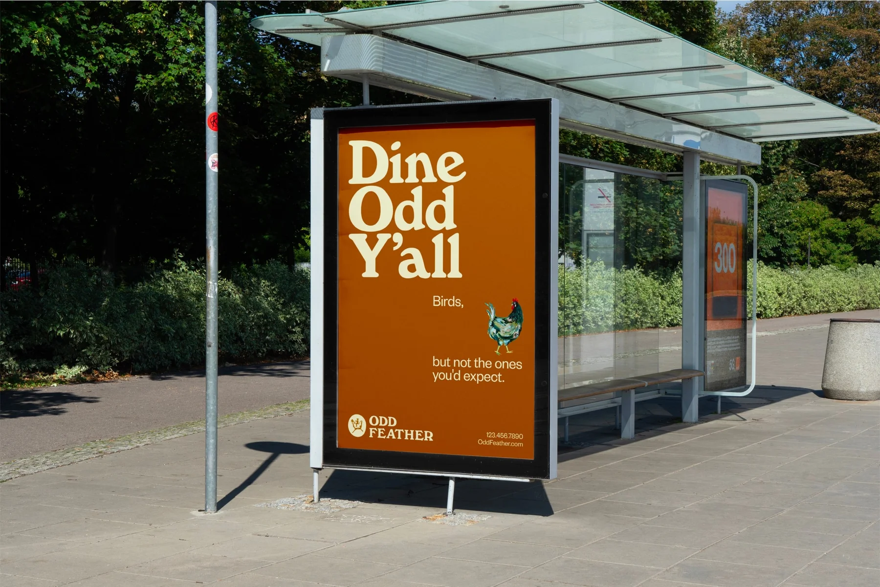 Orange Odd Feather bus-shelter poster reading Dine Odd Y'all.