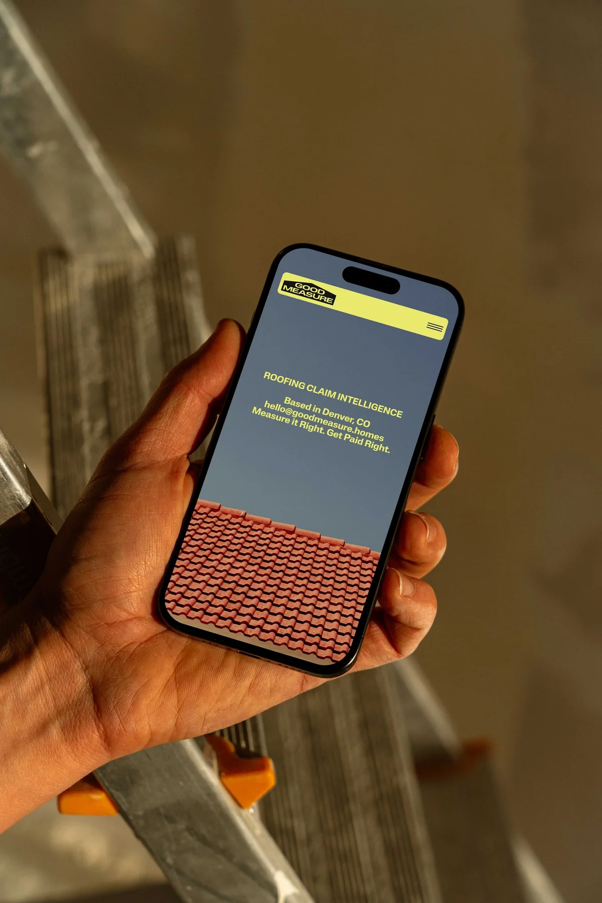 Good Measure mobile website shown on a phone at a construction site.