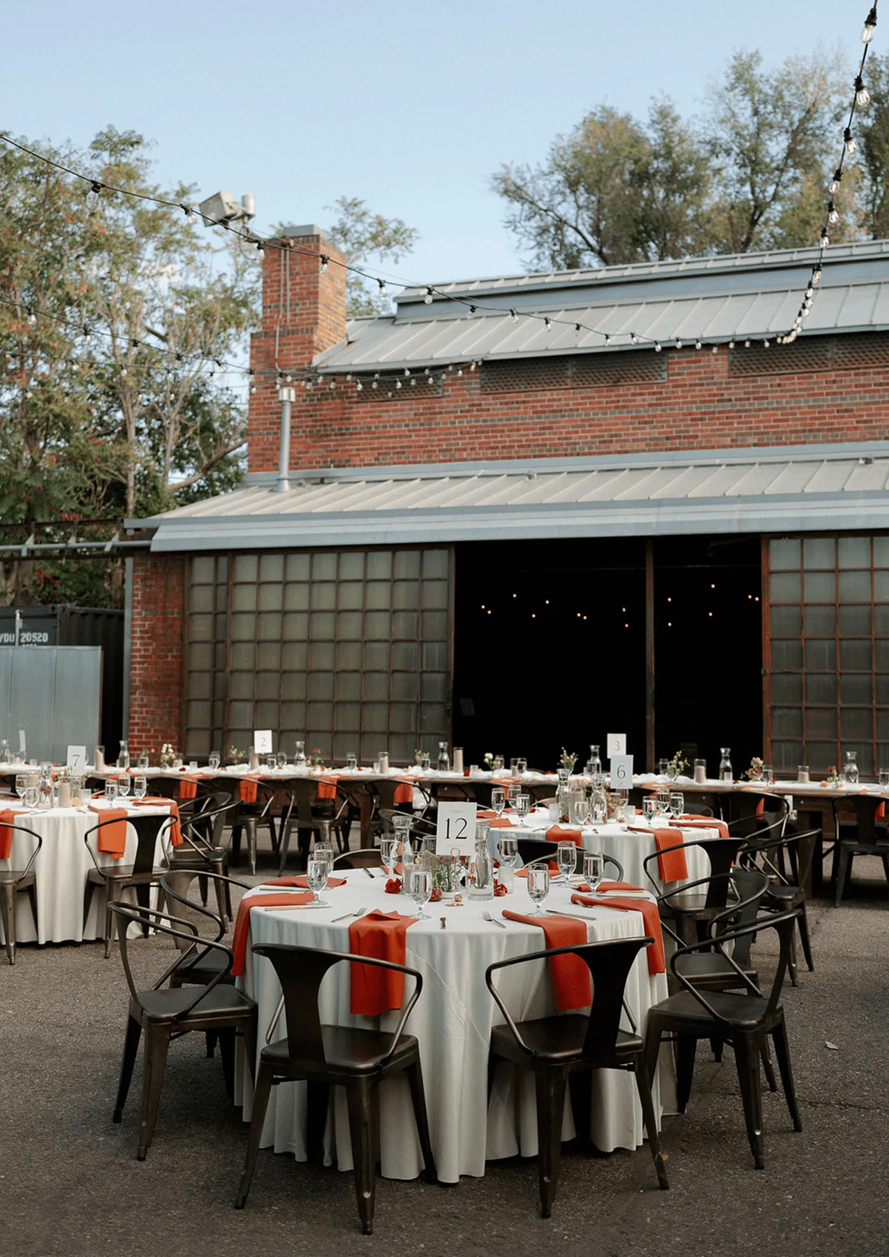 Outdoor dining tables set beside the Blanc venue.