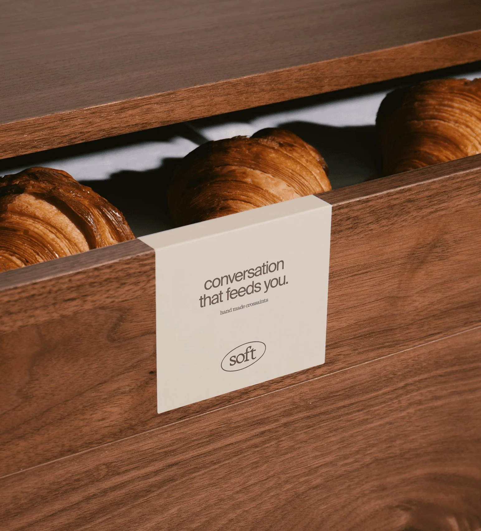 Small Soft card on a wooden pastry display.