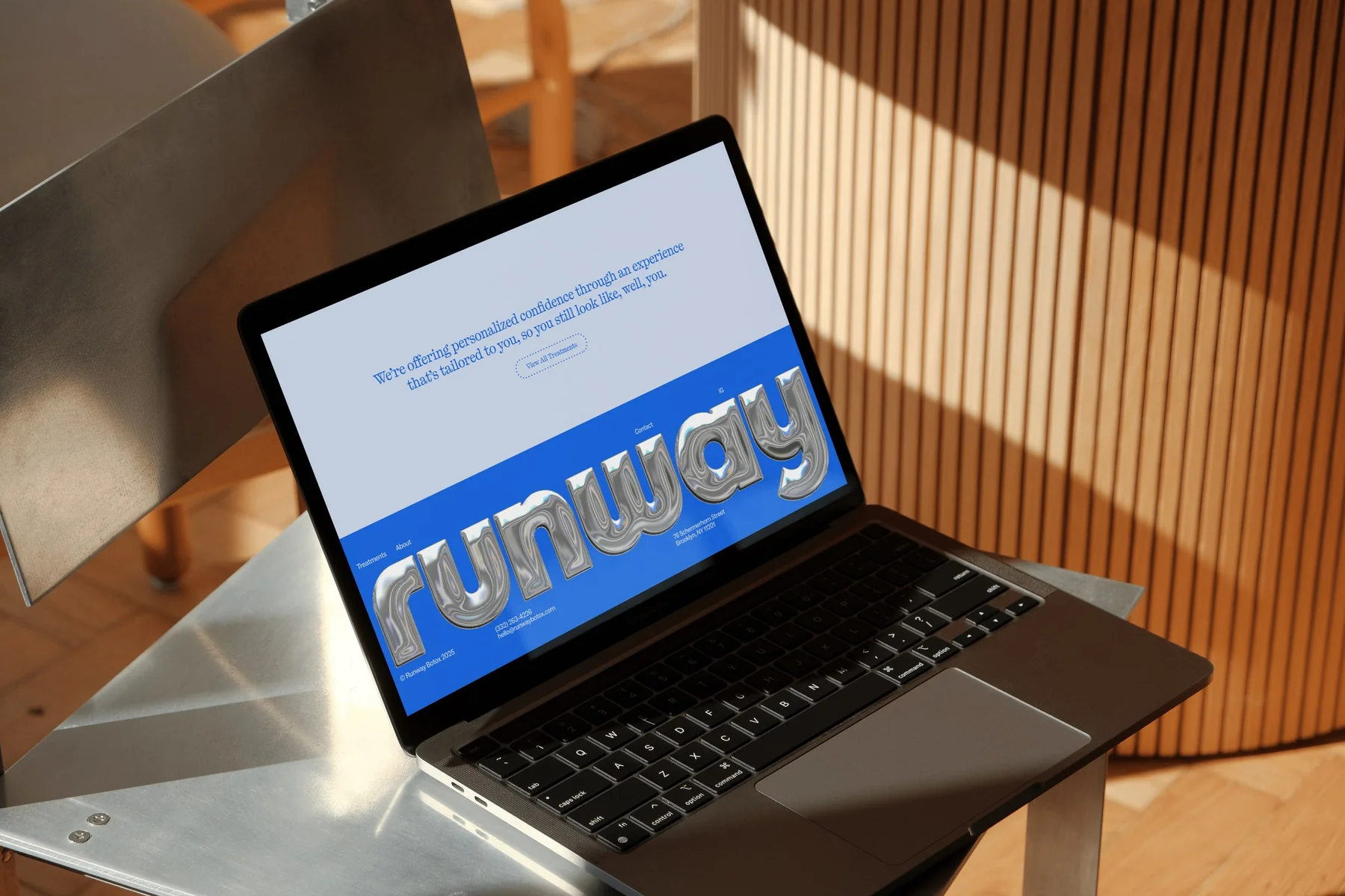 Runway website displayed on a laptop in sunlight.