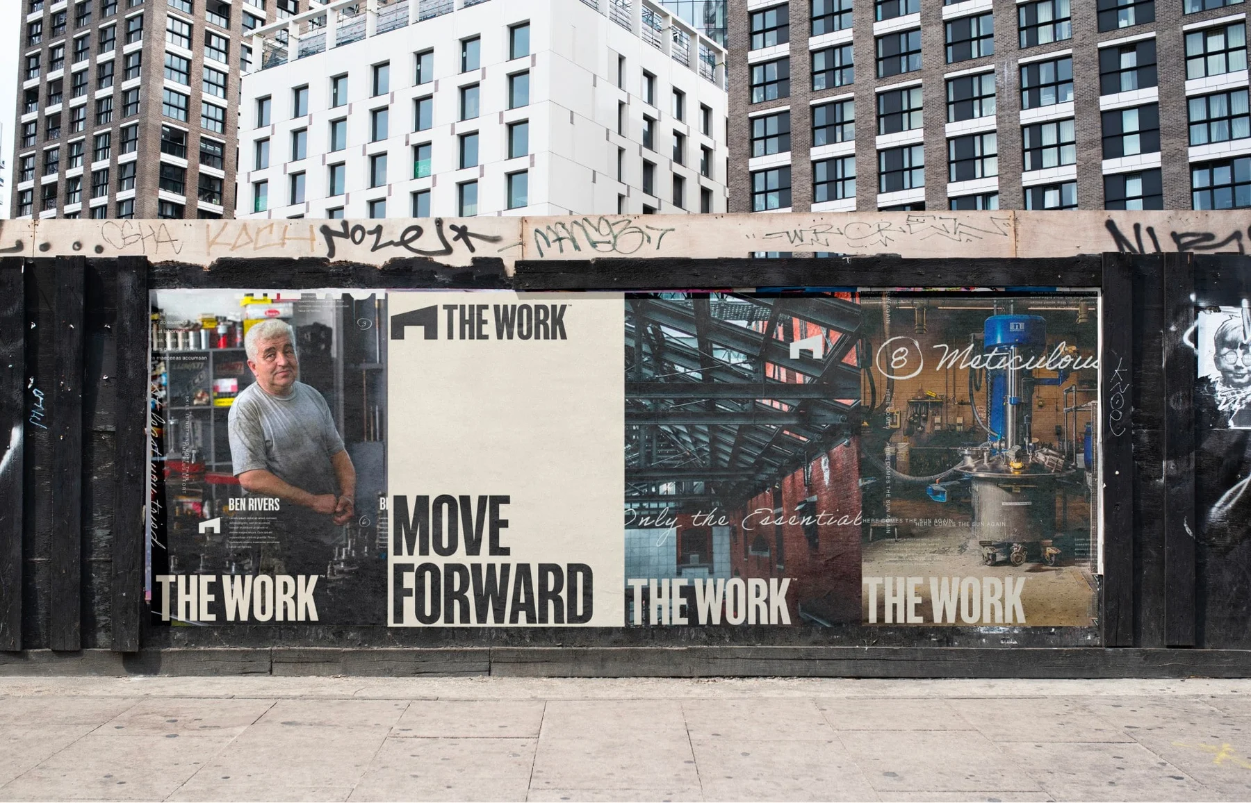The Work posters covering a construction fence.